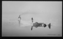 Image of Inuit holds line to dead walrus on ice. BEOTHIC  beyond